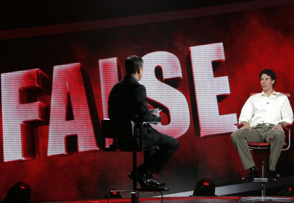 Host Mark Walberg with a contestant on the 2008 show The Moment of Truth.