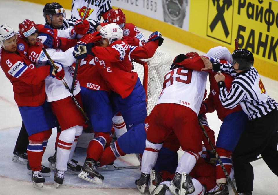 Denmark's and Norway's players scuffle during the Group A preliminary round match between Denmark and Norway at the Ice Hockey World Championship in Minsk, Belarus, Sunday, May 11, 2014. (AP Photo/Sergei Grits)