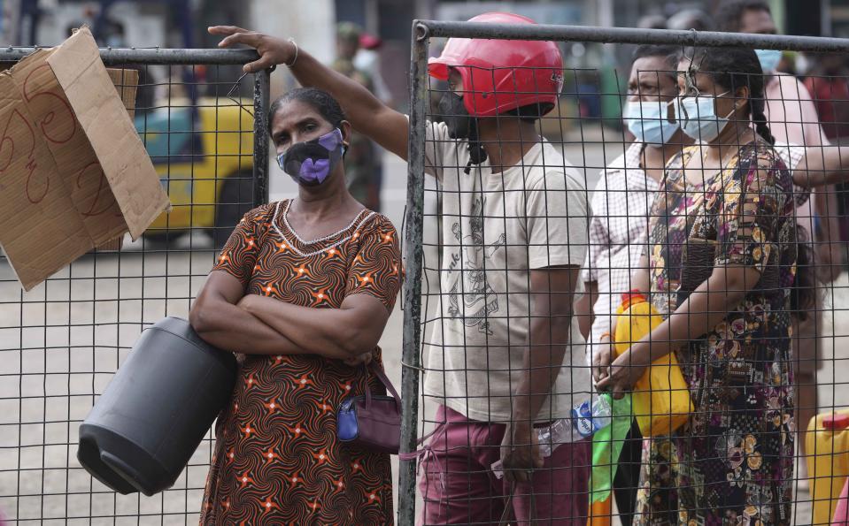 Sri Lankans wait in a queue to buy kerosene oil in Colombo, Sri Lanka, Friday, March 25, 2022. Earlier this month, Sri Lanka’s president requested people’s support by limiting electricity and fuel consumption to cope with the worst economic crisis in memory. (AP Photo/Eranga Jayawardena)