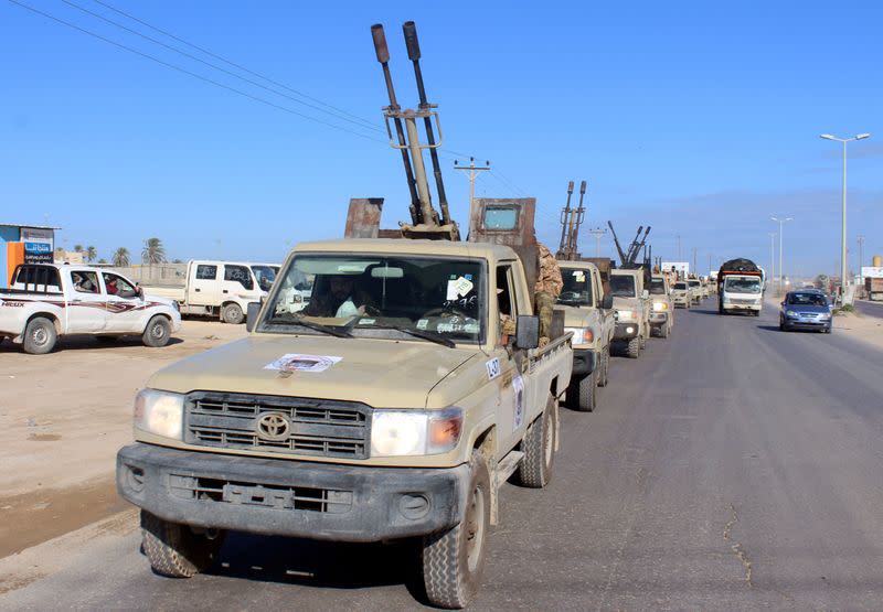 FILE PHOTO: Military vehicles of the Libyan internationally recognised government forces head out to the front line from Misrata