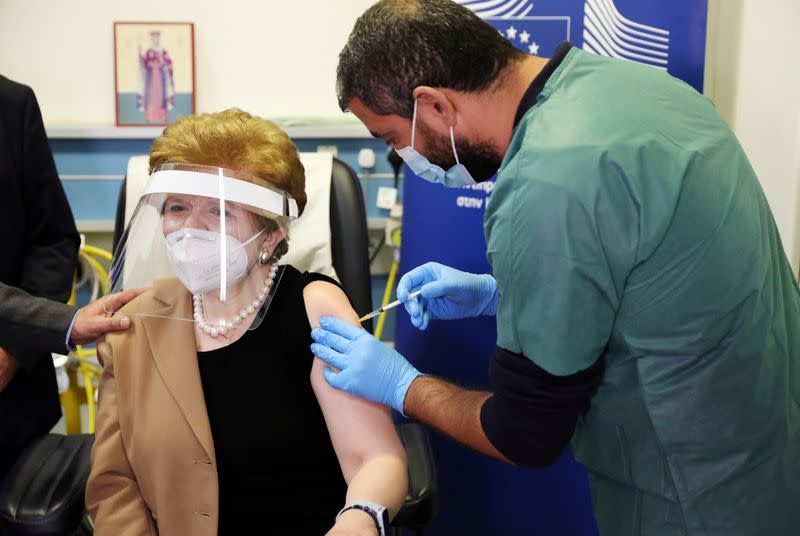 Christina Yiannaki, general manager of the Ministry of Health, receives an injection with a dose of Pfizer-BioNTech COVID-19 vaccine at the Famagusta General Hospital, as the coronavirus disease (COVID-19) outbreak continues, in Dherinia