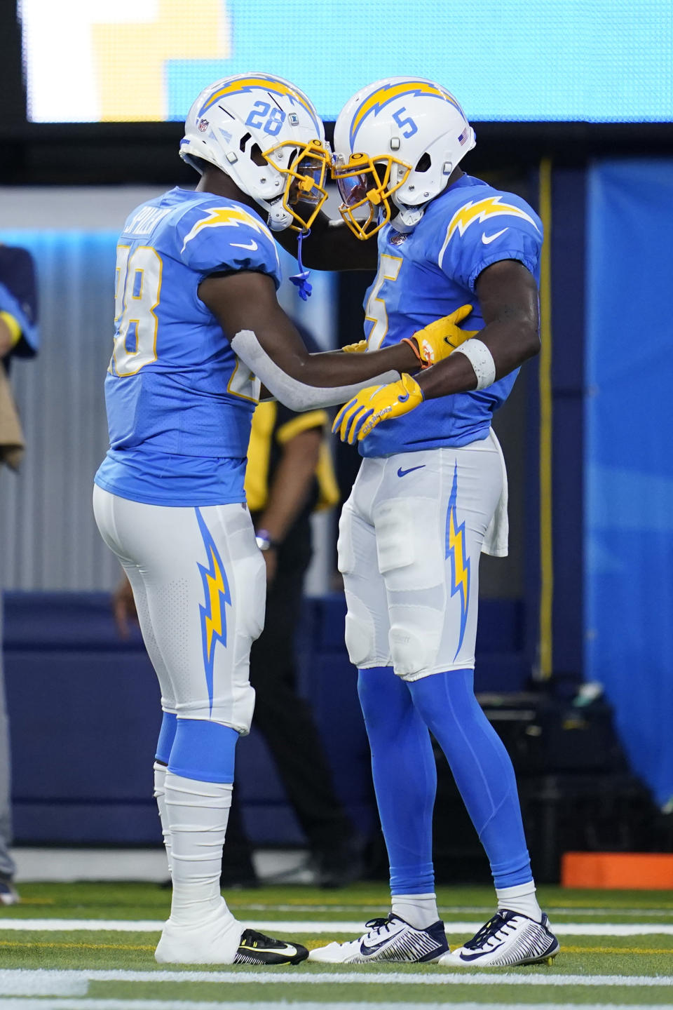 Los Angeles Chargers wide receiver Joshua Palmer (5) celebrates his touchdown catch with running back Isaiah Spiller (28) during the first half of a preseason NFL football game against the Dallas Cowboys Saturday, Aug. 20, 2022, in Inglewood, Calif. (AP Photo/Ashley Landis )