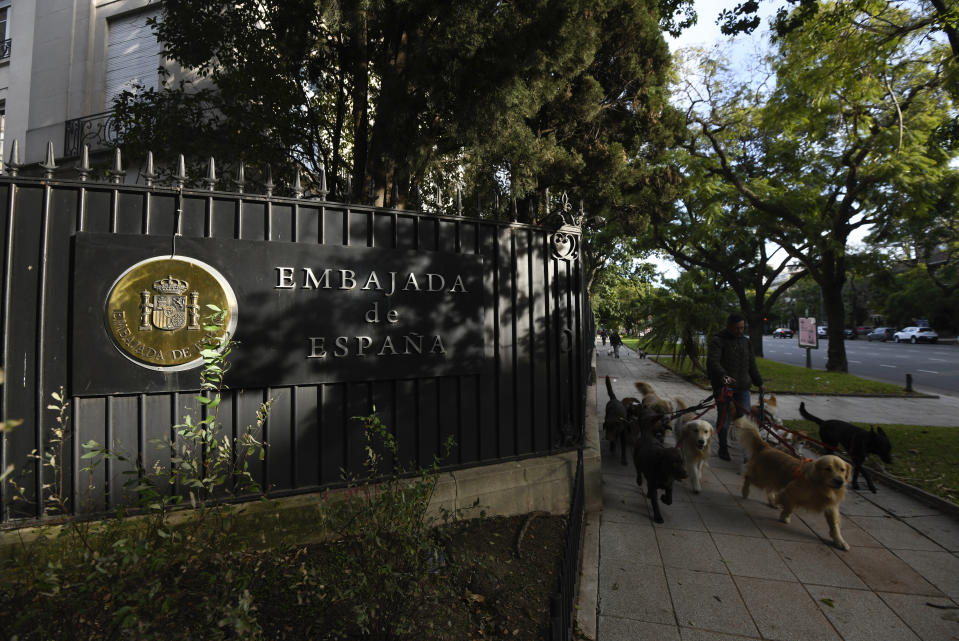 FILE - A man walks dogs past Spain's embassy in the Palermo neighborhood of Buenos Aires, Argentina, Monday, May 20, 2024. A diplomatic crisis between historic allies Spain and Argentina expanded Tuesday, May 21, 2024, as Spain pulled its ambassador from Buenos Aires and Argentine President Javier Milei lambasted the move as “nonsense typical of an arrogant socialist.” (AP Photo/Gustavo Garello, File)