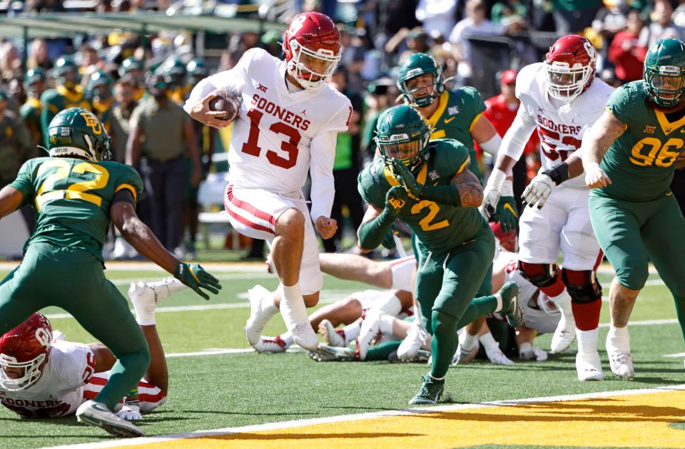 Caleb Williams (13) of Oklahoma jumps over the goal line to score a touchdown against Baylor on Saturday.