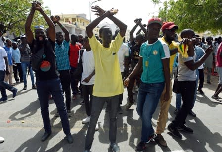 Demonstrators gesture during a protest in Dakar