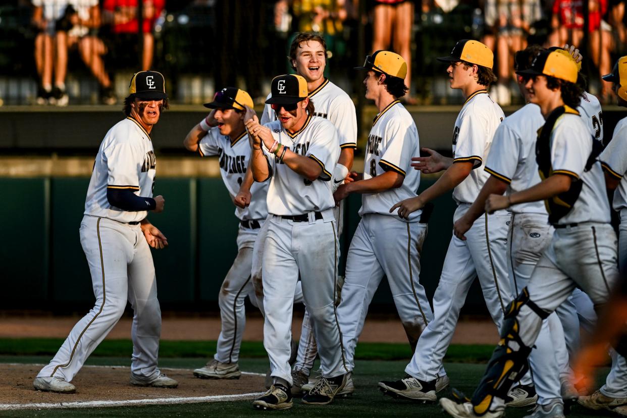 Grand Ledge's Preston Bohnet, center, celebrates with teammates after scoring the game winning run against St. Johns in the 10th inning on Tuesday, May 21, 2024, during the Diamond Classic at MSU's McLane Stadium in East Lansing