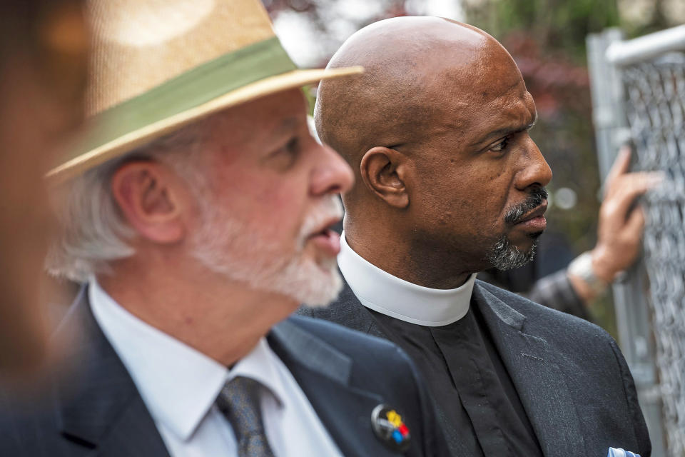 FILE - In this Friday, May 3, 2019 file photo, Pastor Eric Manning, right, of Emanuel AME Church of Charleston, S.C., accompanies Rabbi Jeffrey Myers, of Pittsburgh's Tree of Life Congregation, as he speaks about the memorial for the victims of the Tree of Life Synagogue mass shooting during a special prayer service with survivors and relatives of the Emanuel AME Church mass shooting in 2015 and Tree of Life Synagogue mass shooting in 2018, at Tree of Life Synagogue in Pittsburgh. (Michael M. Santiago/Pittsburgh Post-Gazette via AP)
