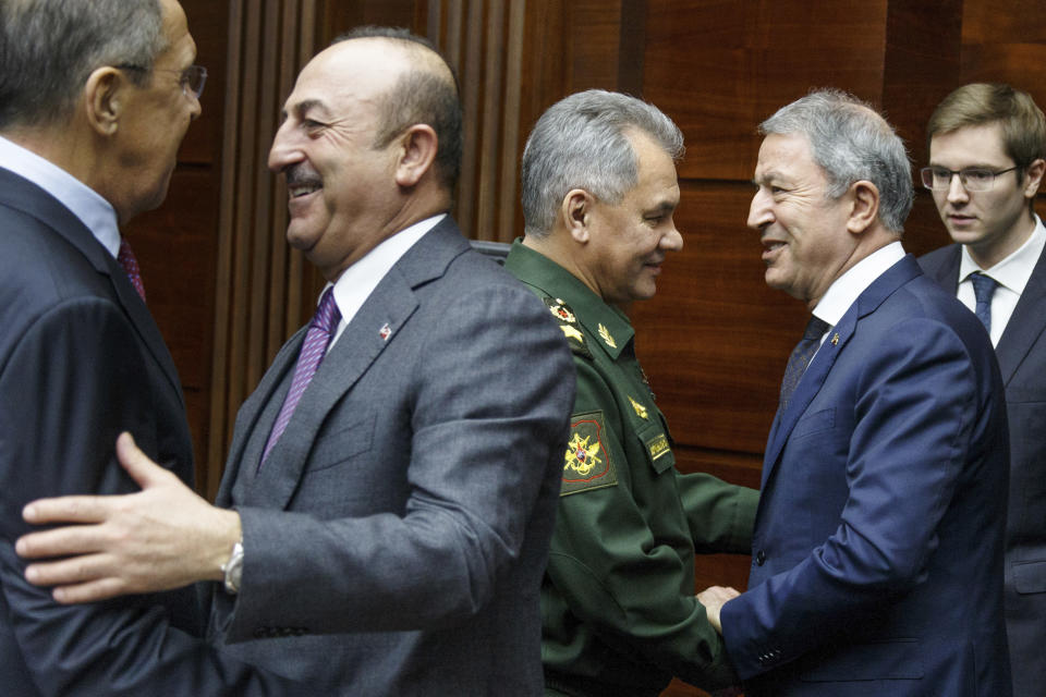 Russian Foreign Minister Sergey Lavrov, left, and Turkey's Foreign Minister Mevlut Cavusoglu, 2nd left, Russian Defense Minister Sergei Shoigu, 3rd left, and Turkey's Defense Minister Hulusi Akar shake hands during their meeting in Moscow, Russia, Saturday, Dec. 29, 2018. (Vadim Savitsky, Russian Defense Ministry Press Service via AP)