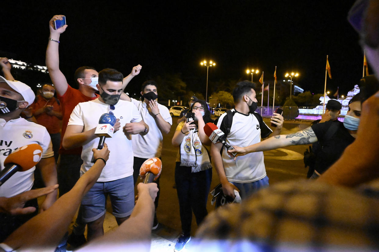 A Real Madrid fans celebrate front of La Cibeles fountain after Real Madrid won La Liga championship in downtown Madrid, Spain, on July 16, 2020. Real Madrid and local authorities asked the supporters not to celebrate the title around the fountain to avoid a new COVID-19 outbreak. Real Madrid got its 34th Spanish Championship after defeating Villarreal (Photo by Oscar Gonzalez/NurPhoto via Getty Images)