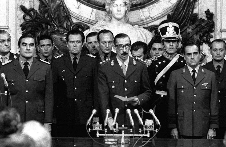 FILE - In this March 24, 1976 file photo, Gen. Jorge Rafael Videla, center, is sworn-in as president at the Buenos Aires Government House accompanied by Adm. Emilio Massera, second from left, and Brig. Orlando Agosti, second from right, members of the junta that overthrew President Isabel Peron. (AP Photo/Eduardo Di Baia, File)