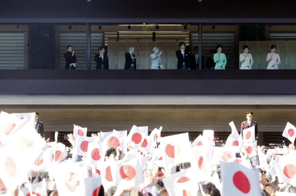 Japan's Emperor Akihito, third left, appears to greet well-wishers from the bullet-proofed balcony during his New Year's public appearance with his family members at Imperial Palace in Tokyo Wednesday, Jan. 2, 2019. (AP Photo/Eugene Hoshiko)