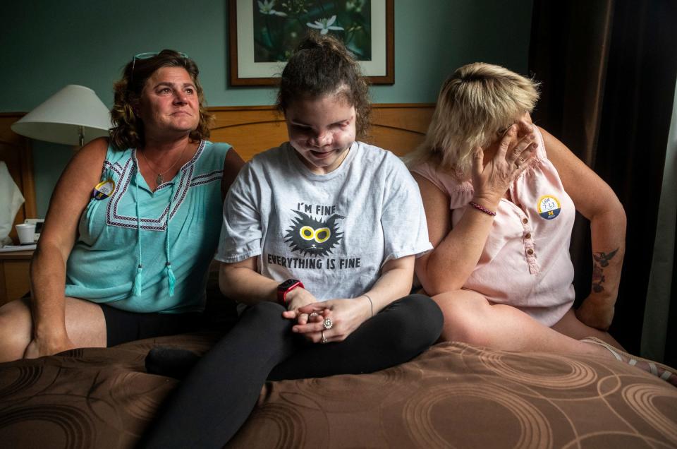 Becki Hoon, left, Amedy Dewey, middle, and Rose Haynor sit inside their room at the Med Inn Building in Ann Arbor on Sunday, July 23, 2023. Hoon and Haynor shed some tears as they remember Dewey's mother, who was shot and killed in a gun violence attack.