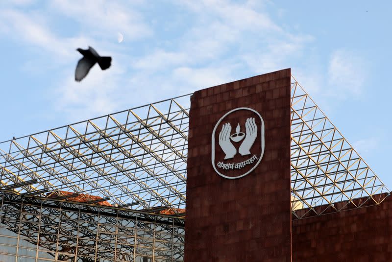 Bird flies past a logo of Life Insurance Corporation of India (LIC) in New Delhi