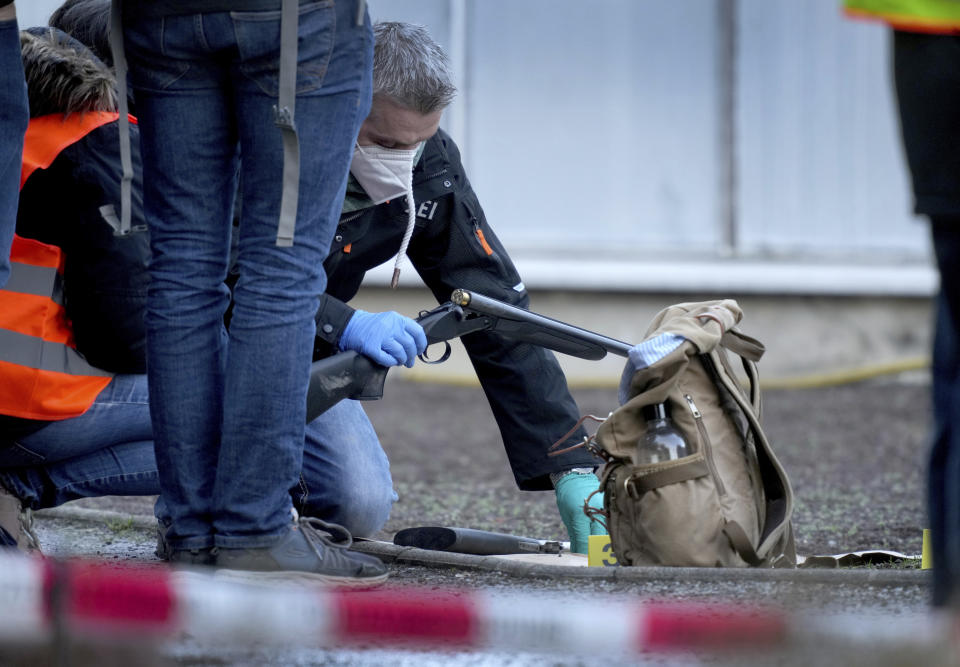 Police officers secure traces on the grounds of the Heidelberg University Botanical Garden in Heidelberg, Germany, Monday, Jan. 24, 2022. German police say a lone gunman wounded several people at a lecture theatre in the southwest city of Heidelberg on Monday. Police said in a brief statement that the perpetrator was dead but didn't give details of how that happened.(AP Photo/Michael Probst)