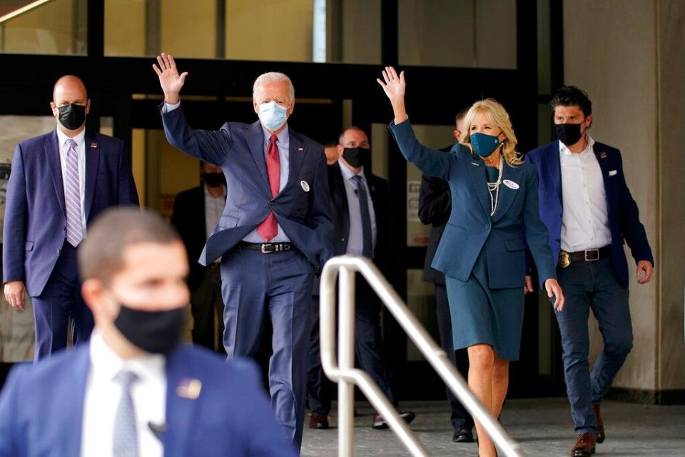 Democratic presidential candidate former Vice President Joe Biden and his wife Jill Biden wave after they voted at the Carvel State Office Building, Wednesday, Oct. 28, 2020, in Wilmington, Del.