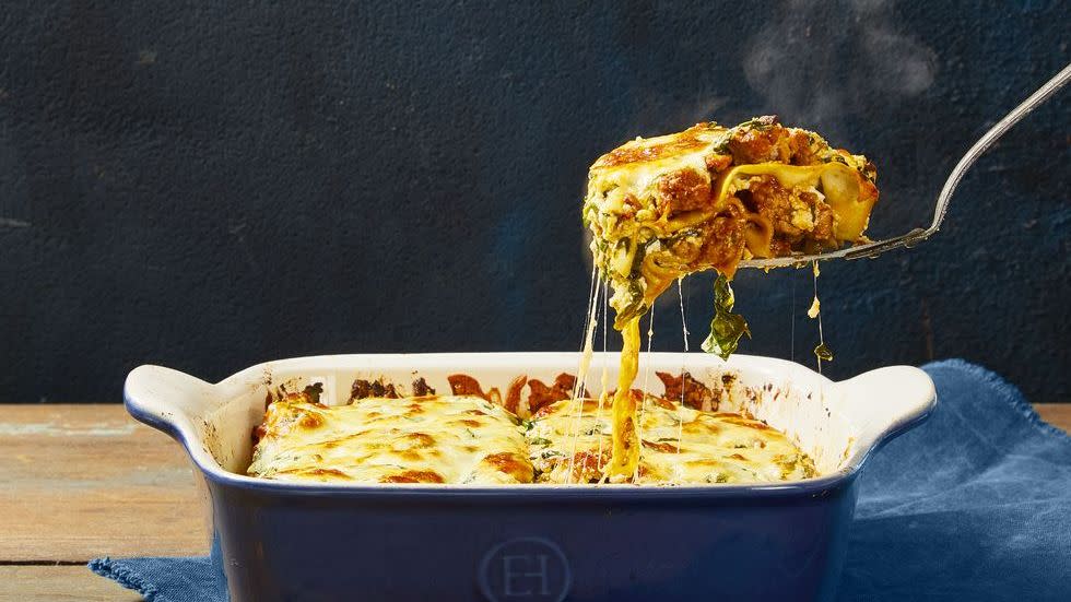 lasagna with meat sauce in a blue baking dish