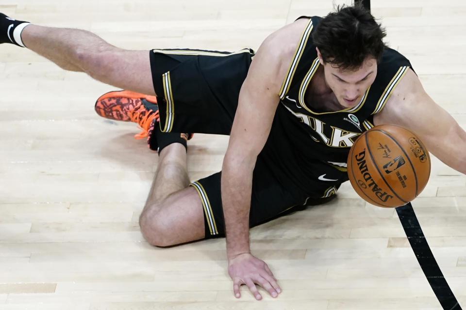 Atlanta Hawks forward Danilo Gallinari (8) falls to the floor after being fouled in the first half of an NBA basketball game against the Boston Celtics Wednesday, Feb. 24, 2021, in Atlanta. (AP Photo/John Bazemore)