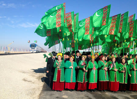 People attend the opening ceremony of a railway link to Afghanistan in the Ymamnazar customs control point, Turkmenistan, November 28, 2016. REUTERS/Marat Gurt