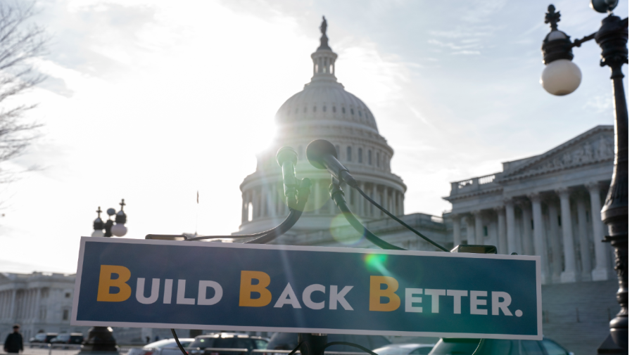 With the U.S. Capitol dome in the background, a sign that reads "Build Back Better" is displayed before a news conference, Wednesday, Dec. 15, 2021, on Capitol Hill in Washington.