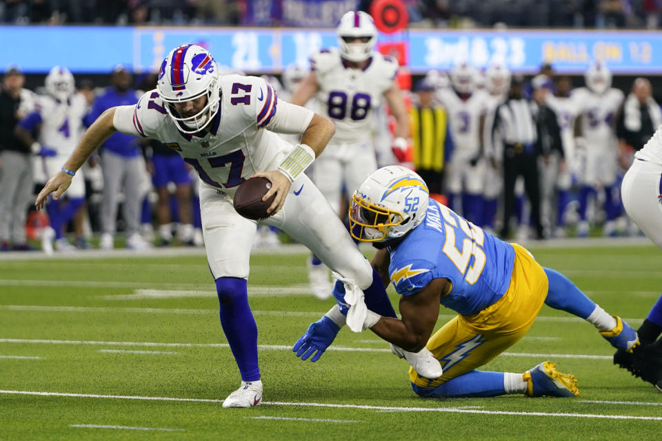 Buffalo Bills quarterback Josh Allen (17) is pressured by Los Angeles Chargers linebacker Khalil Mack (52) during the second half of an NFL football game Saturday, Dec. 23, 2023, in Inglewood, Calif. (AP Photo/Ryan Sun)