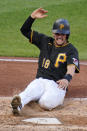 Pittsburgh Pirates' John Ryan Murphy scores one of three runs on a single by Ke'Bryan Hayes off St. Louis Cardinals starting pitcher Carlos Martinez during the fourth inning of the first baseball game of a doubleheader in Pittsburgh, Friday, Sept. 18, 2020. (AP Photo/Gene J. Puskar)