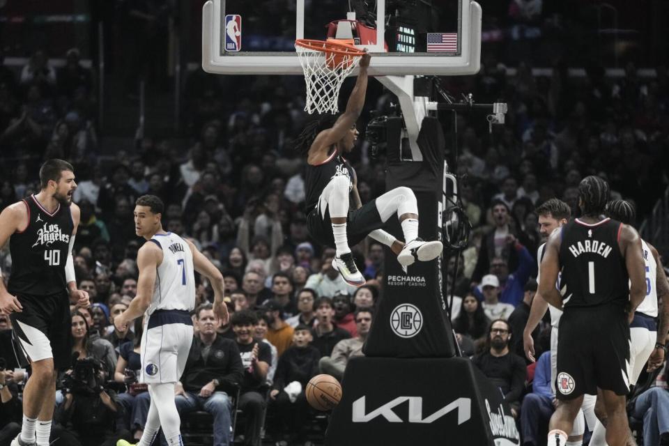 The Clippers' Terance Mann celebrates after dunking the ball during a game against the Mavericks