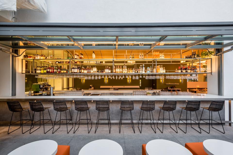 The indoor/outdoor bar connects the dining room to a courtyard.