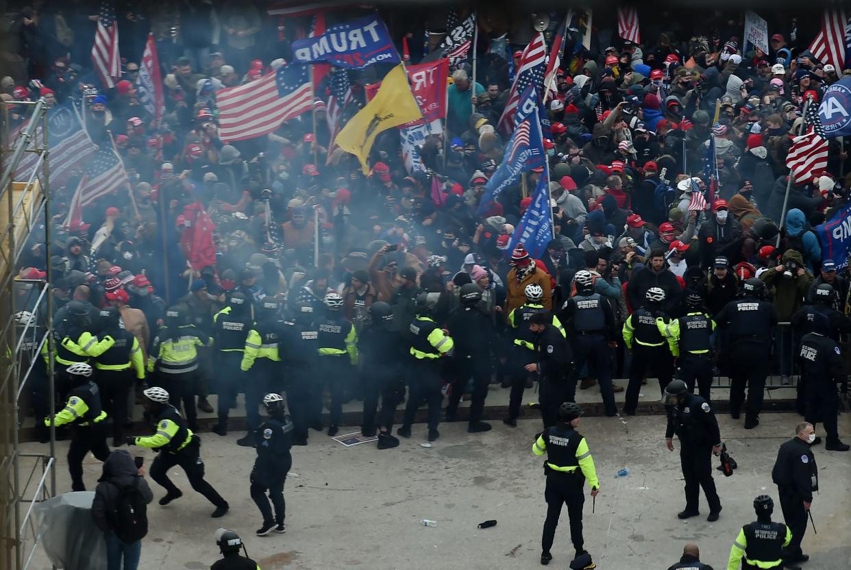 Police hold back supporters of US President Donald Trump as they gather outside the US Capitol's Rotunda on January 6, 2021, in Washington, DC. Demonstrators breeched security and entered the Capitol as Congress debated the 2020 presidential election Electoral Vote Certification.