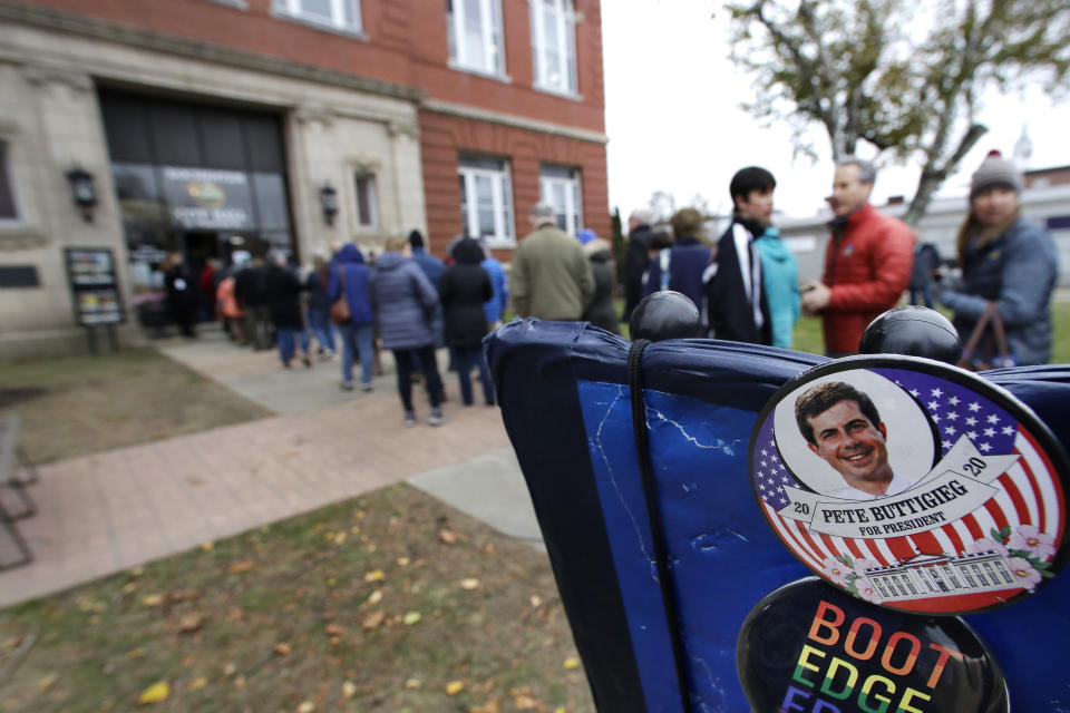 Campaign buttons are displayed as people wait outside the Rochester Opera House to hear Democratic presidential candidate South Bend, Ind. Mayor Pete Buttigieg deliver a Veterans Day address, Monday, Nov. 11, 2019, in Rochester, N.H. (AP Photo/Elise Amendola)