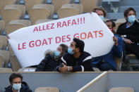 Spectators hold a banner referring to Spain's Rafael Nadal as the Greatest Of All Time of the Greatest of All Time, in his match against Argentina's Diego Schwartzman in the semifinal of the French Open tennis tournament at the Roland Garros stadium in Paris, France, Friday, Oct. 9, 2020. (AP Photo/Michel Euler)