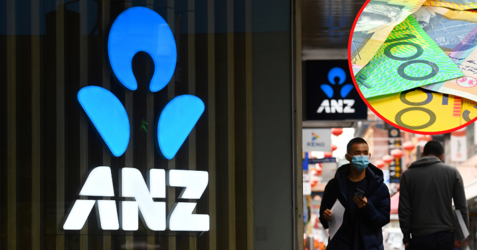 ANZ logo on. the side of a branch with people waling by in the street while wearing masks.