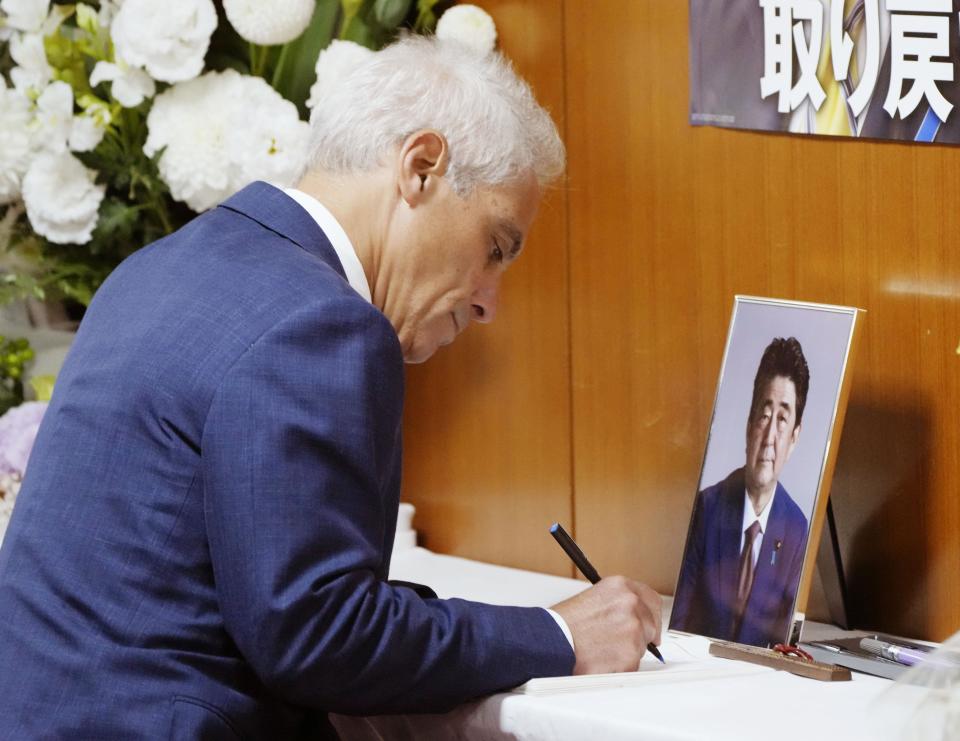 U.S. Ambassador to Japan Rahm Emanuel signs a book of condolences for former Japanese Prime Minister Shinzo Abe at the headquarters of the ruling Liberal Democratic Party in Tokyo, Thursday, July 14, 2022. Abe was fatally shot last week in western Japan while giving a campaign speech.(Kyodo News via AP)