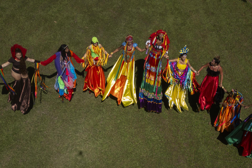 Raquel Potí, fourth from left, and fellow stilt walkers prepare to perform during the Terreirada Cearense street Carnival party, in Rio de Janeiro, Brazil, Saturday, Feb. 10, 2024. (AP Photo/Bruna Prado)