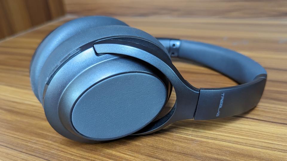 Treblab Z7 Pro wireless headphones on a wooden table.