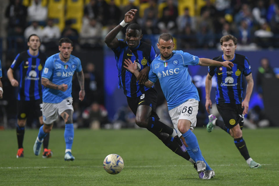 Napoli's Stanislav Lobotka, front right, fights for the ball with Inter Milan's Marcus Thuram, front left, during the Italian Super Cup final soccer match between Inter Milan and Napoli at Al Awwal Park Stadium in Riyadh, Saudi Arabia, Monday, Jan. 22, 2024. (AP Photo)