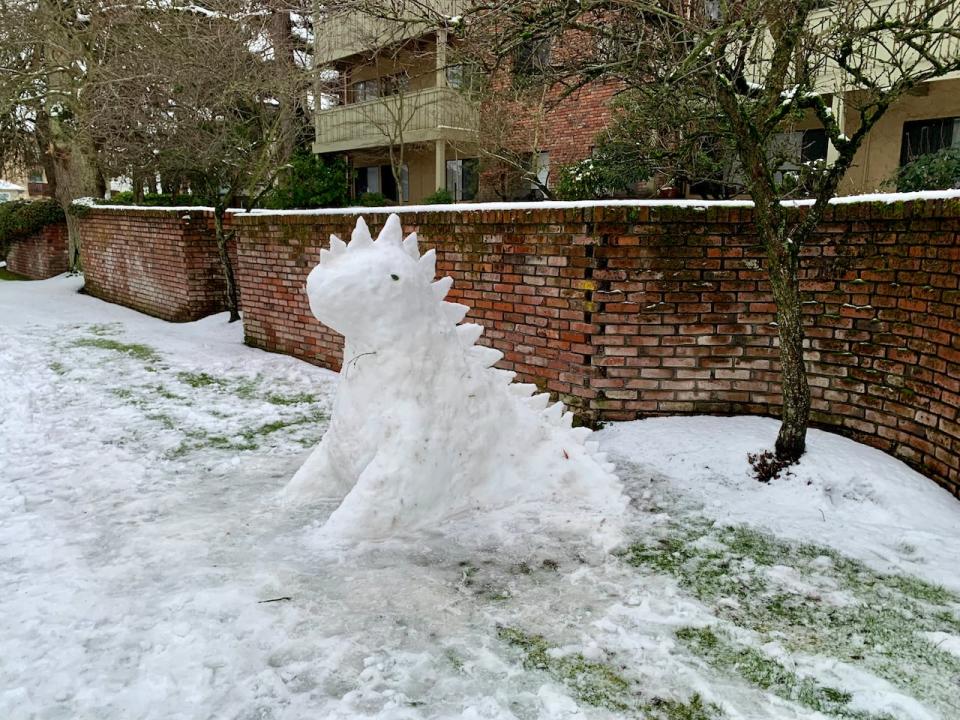 A 'snow dinosaur' is seen in Victoria on Thursday morning. While many schools were open in the provincial capital, they shut early due to a fierce snowstorm.