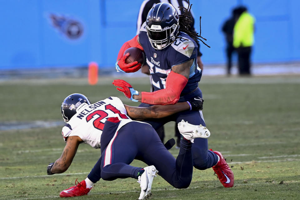 Tennessee Titans running back Derrick Henry (22) moves past Houston Texans cornerback Steven Nelson (21) during the second half of an NFL football game, Saturday, Dec. 24, 2022, in Nashville, Tenn. (AP Photo/Mark Zaleski)