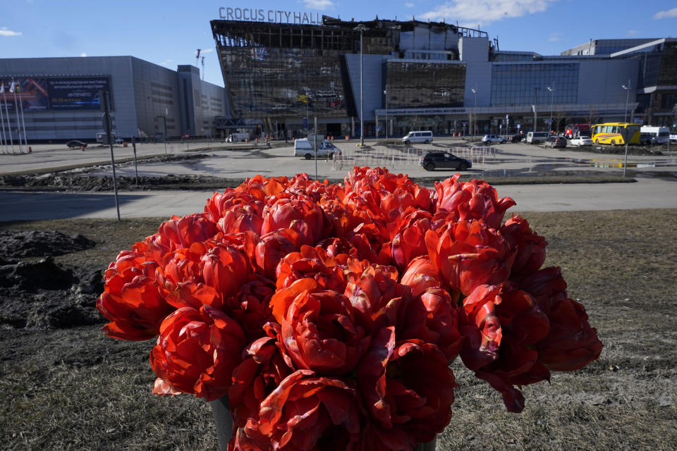 Flowers lie in front of the Crocus City Hall on the western outskirts of Moscow, Russia, Wednesday, March 27, 2024. Russian officials persisted Tuesday in saying Ukraine and the West had a role in last week's deadly Moscow concert hall attack despite vehement denials of involvement by Kyiv and a claim of responsibility by an affiliate of the Islamic State group. (AP Photo/Alexander Zemlianichenko)