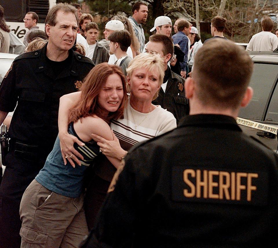 A mother and daughter are reunited after a shooting April, 20, 1999, at Columbine High School in Littleton, Colo. Two students killed 12 others and a teacher before dying by suicide.