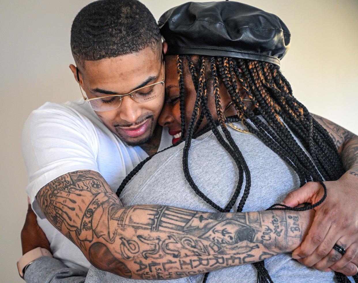 Keith Davis Jr. hugs his wife Kelly during a celebration following his released from custody Friday, Jan. 13, 2023, in Baltimore, after prosecutors dropped all charges against him. Davis was tried for the same murder four times and was awaiting a potential fifth trial when newly elected State's Attorney Ivan Bates announced his decision to dismiss the case. (Jerry Jackson/The Baltimore Sun via AP) ORG XMIT: MDBAE201