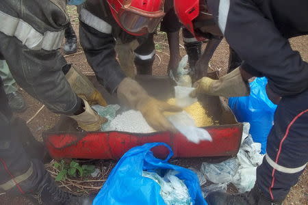 Senegalese police prepare to incinerate methamphetamines seized at the Malian border in Tambacounda, Senegal, June 29, 2014. REUTERS/Pape Demba Sidibe