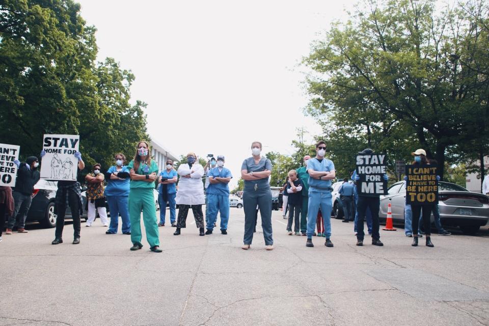 Health care workers holding a counterprotest against anti-lockdown demonstrators in Raleigh, North Carolina, on Tuesday.  (Photo: Jade Wilson )