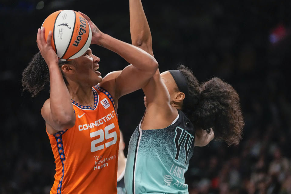 Connecticut Sun forward Alyssa Thomas (25) goes to the basket against New York Liberty forward Betnijah Laney (44) during the first half of Game 2 of a WNBA basketball playoffs semifinal, Tuesday, Sept. 26, 2023, in New York. (AP Photo/Mary Altaffer)