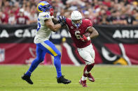 Arizona Cardinals running back James Conner (6) pushes off of Los Angeles Rams linebacker Bobby Wagner (45) during the second half of an NFL football game, Sunday, Sept. 25, 2022, in Glendale, Ariz. (AP Photo/Ross D. Franklin)