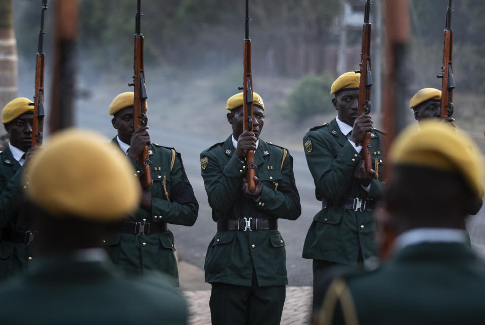 The presidential guard await the arrival of the body of former president Robert Mugabe at his official residence in the capital Harare, Zimbabwe Wednesday, Sept. 11, 2019. Zimbabwe's founding leader Robert Mugabe made his final journey back to the country Wednesday, his body flown into the capital amid the contradictions of his long, controversial rule. (AP Photo/Ben Curtis)