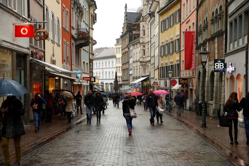 FILE PHOTO: People walk on a shopping street in the southern German town of Konstanz