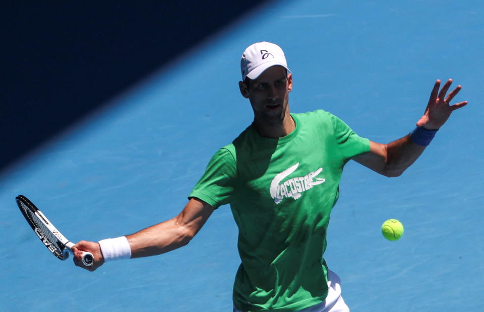 Novak Djokovic warms up in Australia as he awaits a final verdict on his status. (Loren Elliott / Reuters)