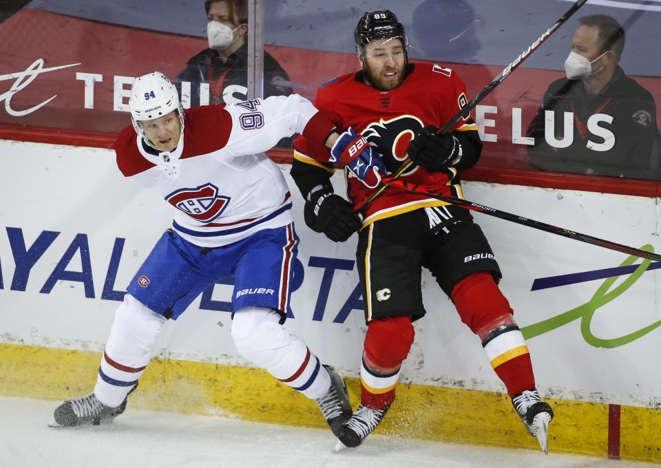 Montreal Canadiens' Corey Perry, left, checks Calgary Flames' Nikita Nesterov during the first period of an NHL hockey game Friday, April 23, 2021, in Calgary, Alberta. (Jeff McIntosh/The Canadian Press via AP)