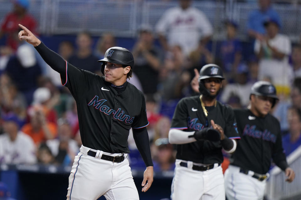 Miami Marlins' JJ Bleday, left, Lewin Diaz, center, and Avisail Garcia celebrate after they scored on a double by Miguel Rojas during the first inning of a baseball game against the New York Mets, Friday, July 29, 2022, in Miami. (AP Photo/Wilfredo Lee)