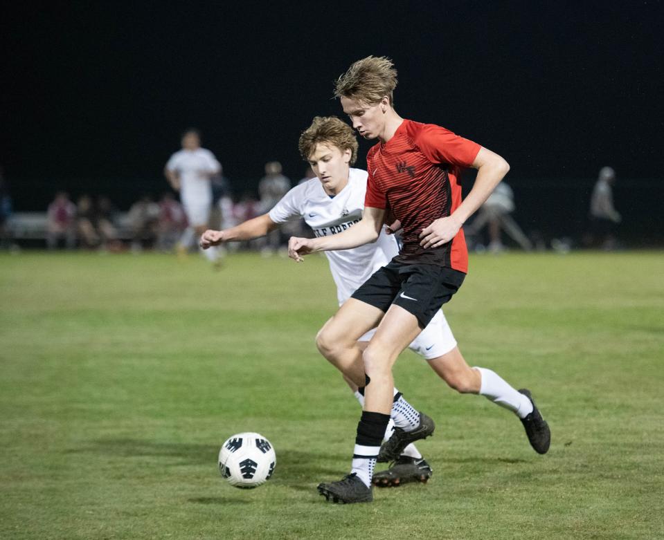 Gunnar Brown (19) controls the ball in front of Lucas Isakson (18) during the Gulf Breeze vs West Florida boys soccer game at Ashton Brosnaham Park in Pensacola on Wednesday, Dec. 7, 2022.